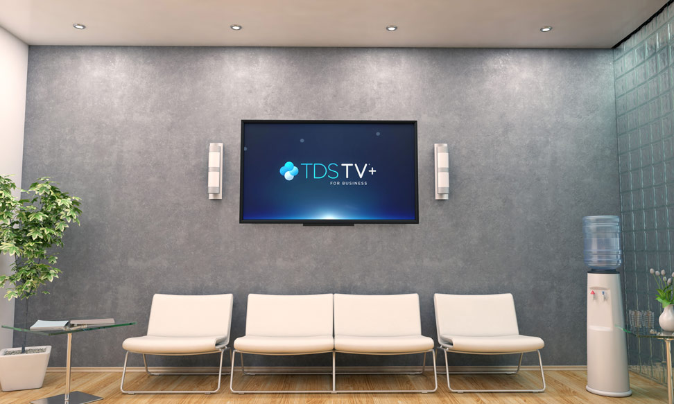 Waiting room with four right chairs and a mounted TV with TDS TV+ logo